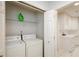 Convenient laundry closet featuring stacked washer and dryer, with shelving above for storage at 211 Colonial Homes Nw Dr # 2304, Atlanta, GA 30309