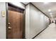 Hallway view of apartment 2309 with neutral colored wall and door, and a carpeted floor in an apartment building at 855 Peachtree Ne St # 2309, Atlanta, GA 30308