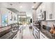 Modern kitchen featuring an eat-in island and stainless steel appliances, seamlessly connected to an adjoining living space at 855 Peachtree Ne St # 2309, Atlanta, GA 30308