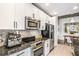 Well-equipped kitchen with white cabinets, granite countertops, and stainless steel appliances at 855 Peachtree Ne St # 2309, Atlanta, GA 30308