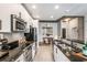 Well-equipped kitchen featuring modern stainless steel appliances, dark countertops, and sleek white cabinetry and subway tile backsplash at 855 Peachtree Ne St # 2309, Atlanta, GA 30308