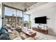 Bright living room with floor-to-ceiling windows and access to balcony at 855 Peachtree Ne St # 2309, Atlanta, GA 30308