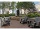 Outdoor seating area with modern black lounge chairs surrounding a water feature with landscaping and greenery at 855 Peachtree Ne St # 2309, Atlanta, GA 30308