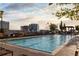 Beautiful rooftop pool with lounge chairs overlooking the city skyline on a sunny day at 855 Peachtree Ne St # 2309, Atlanta, GA 30308