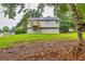 A view of the back of the home featuring a deck overlooking the grassy yard at 240 Mountain Ln, Covington, GA 30016