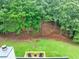 A cozy backyard deck area with chairs offers a serene view of the surrounding lush greenery at 240 Mountain Ln, Covington, GA 30016