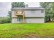 Exterior of the house with a wooden deck overlooking a well manicured lawn at 240 Mountain Ln, Covington, GA 30016