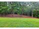 View of a large, treed backyard, creating a serene and private outdoor space at 240 Mountain Ln, Covington, GA 30016