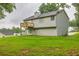 Exterior of the house with a wooden deck overlooking a well manicured lawn at 240 Mountain Ln, Covington, GA 30016