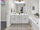 Bathroom with a double sink vanity, and tub, providing ample space and functionality at 240 Mountain Ln, Covington, GA 30016