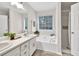 Bright bathroom featuring a soaking tub and separate shower, perfect for relaxation and convenience at 240 Mountain Ln, Covington, GA 30016