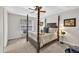 Bedroom with cozy carpet, a four poster bed, and natural light from the window at 240 Mountain Ln, Covington, GA 30016