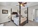 Bedroom featuring a four-poster bed, neutral walls, carpeted floor, and a ceiling fan at 240 Mountain Ln, Covington, GA 30016