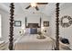 Bedroom featuring a four poster bed, patterned ceiling, neutral colors, and stylish decor at 240 Mountain Ln, Covington, GA 30016