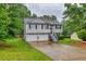 Charming two-story home with a two car garage and manicured front yard at 240 Mountain Ln, Covington, GA 30016