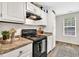 Close up of range and granite counters in renovated kitchen at 240 Mountain Ln, Covington, GA 30016