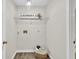 Laundry area with wire shelving and durable laminate wood flooring at 240 Mountain Ln, Covington, GA 30016