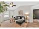 Bright living room features vaulted ceiling, fireplace, stylish decor, and modern ceiling fan at 240 Mountain Ln, Covington, GA 30016
