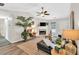 Bright living room features vaulted ceiling, fireplace, stylish decor, and modern ceiling fan at 240 Mountain Ln, Covington, GA 30016