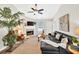 Bright living room features vaulted ceiling, fireplace, stylish decor, and modern ceiling fan at 240 Mountain Ln, Covington, GA 30016