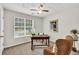 Home office bathed in natural light from large window, featuring cozy furniture at 240 Mountain Ln, Covington, GA 30016