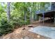 Secluded backyard setting surrounded by trees, features a concrete patio and a fire pit area for outdoor enjoyment at 2960 Cedar Knoll Dr, Roswell, GA 30076