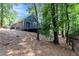 Backyard deck view of home surrounded by mature trees offering privacy at 2960 Cedar Knoll Dr, Roswell, GA 30076
