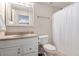 Well-lit bathroom with white vanity and neutral countertop, includes medicine cabinet and shower with white curtain at 2960 Cedar Knoll Dr, Roswell, GA 30076