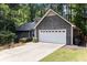 Front exterior of house with an attached garage, well-manicured lawn, and mature trees at 2960 Cedar Knoll Dr, Roswell, GA 30076