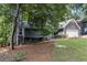 Exterior view of the house with a well manicured lawn and a large tree in the foreground at 2960 Cedar Knoll Dr, Roswell, GA 30076
