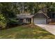 Attractive home with a well-manicured lawn, garage, and daylight windows at 2960 Cedar Knoll Dr, Roswell, GA 30076