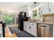 Bright kitchen with white cabinetry, stainless steel appliances, hardwood floors, and sliding doors to the deck at 2960 Cedar Knoll Dr, Roswell, GA 30076