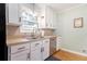 This kitchen features white cabinets, stainless steel appliances, and a tile backsplash at 2960 Cedar Knoll Dr, Roswell, GA 30076
