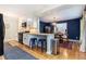 Open kitchen featuring a breakfast bar, white cabinets, stainless steel appliances, and hardwood floors at 2960 Cedar Knoll Dr, Roswell, GA 30076