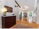 Inviting foyer featuring an antique chest, opening into a spacious living area with hardwood floors and a stone fireplace at 2960 Cedar Knoll Dr, Roswell, GA 30076