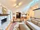 Spacious living room featuring a stone fireplace, hardwood floors, vaulted ceilings, and seamless access to dining at 2960 Cedar Knoll Dr, Roswell, GA 30076