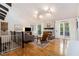 Bright living room with hardwood floors, a stone fireplace, and a staircase with railing, providing an open airy space at 2960 Cedar Knoll Dr, Roswell, GA 30076
