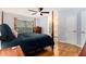 A large main bedroom features wood floors, a ceiling fan, and ensuite bathroom at 2960 Cedar Knoll Dr, Roswell, GA 30076