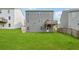 Exterior of home with large, grassy backyard and small wooden deck at 96 Quail Bend Way, Dallas, GA 30157