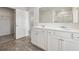 Bright bathroom featuring double sink vanity, large mirror, and neutral finishes at 96 Quail Bend Way, Dallas, GA 30157