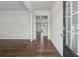 Bright entryway with dark hardwood floors, white walls, and a view of the staircase to the upper level at 96 Quail Bend Way, Dallas, GA 30157
