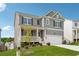 Attractive two-story home with gray siding, black shutters, a covered porch and a well-maintained lawn at 96 Quail Bend Way, Dallas, GA 30157