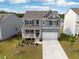 Beautiful two-story home with a welcoming front porch and a well-manicured lawn at 96 Quail Bend Way, Dallas, GA 30157