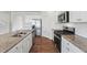 Bright kitchen with granite countertops, white subway tile backsplash, and stainless-steel appliances at 96 Quail Bend Way, Dallas, GA 30157