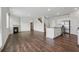 Open-concept living room with a fireplace, island, and hardwood flooring at 96 Quail Bend Way, Dallas, GA 30157