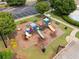 Aerial view of a colorful community playground with slides, climbing structures, and benches at 96 Quail Bend Way, Dallas, GA 30157