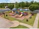 Community playground featuring slides and play structures next to a basketball court and parking area at 96 Quail Bend Way, Dallas, GA 30157