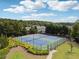 Community tennis courts surrounded by mature trees and lush landscaping, perfect for recreation at 96 Quail Bend Way, Dallas, GA 30157
