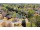 Scenic aerial view of a neighborhood featuring homes surrounding a serene pond with a charming gazebo at 13090 Magnolia Crescent Dr, Roswell, GA 30075