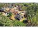 Stunning aerial view of the home surrounded by mature trees in a peaceful neighborhood at 13090 Magnolia Crescent Dr, Roswell, GA 30075